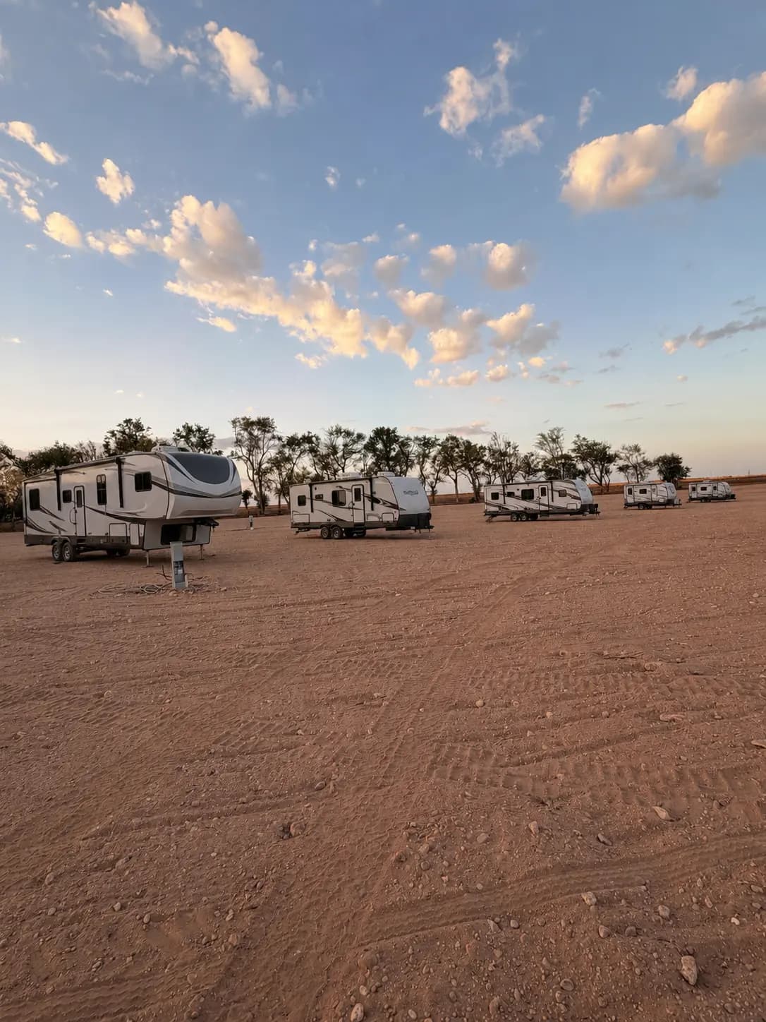 RVs parked at The Gasoline Getaway beneath a West Texas sunset